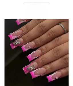 Close-up of French press-on nails with pink zebra stripes and 3D flower accents