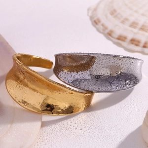 Water drops on 18K gold and silver wavy bangles with concave texture on sea shell