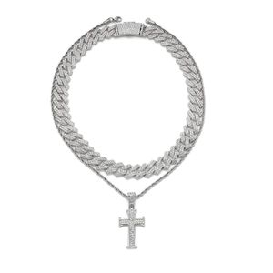 Macro shot of silver iced-out Cuban chain and cross pendant with sparkling rhinestones