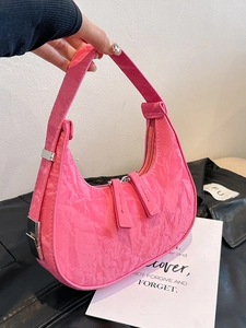 Pink crescent hobo bag with pleated glossy texture and silver metal hardware accents