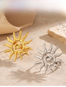 Detail shot of vintage 18K gold and silver sun rings with hammered metal texture