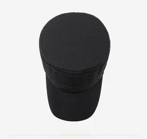 Top view of a black flat top military cap showing the structured crown and cotton twill texture