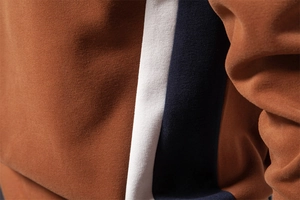 Detailed close-up of premium tri-color stitching on slim fit cotton blend sweatshirt