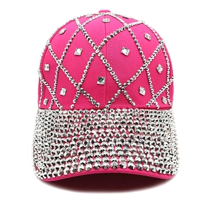Detailed close-up of pink baseball cap with sparkling silver rhinestone grid patterns