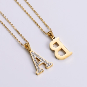 Detailed view of 18k gold plated necklaces with zircon paved A and B letter pendants