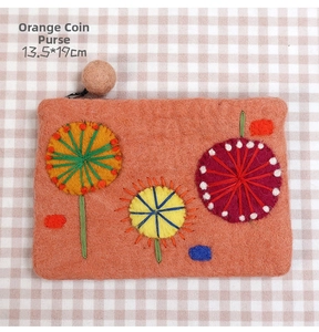 Detail of orange wool felt pouch with handmade floral embroidery and wooden zip puller