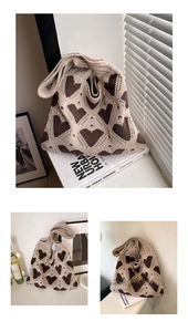Detail of knit tote bag featuring dark brown heart patterns and thick yarn texture