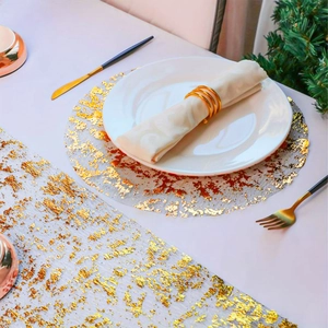 Detailed top view of gold foil mesh table runner and round placemat set for weddings