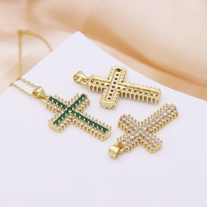 Cross pendant necklace with green and white zircons on a gold-plated base