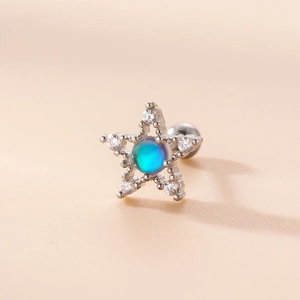 Macro detail of silver star stud earring with blue opal stone and clear zircon accents