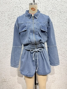 Detail view of light blue denim set with zippered jacket and drawstring high-waisted shorts