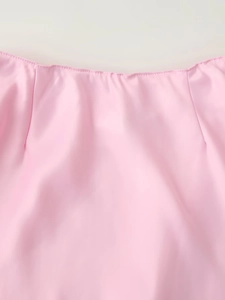 Detailed close-up showing the smooth pink satin fabric and premium rolled hem stitching
