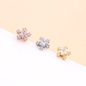 Detailed view of heart and star zircon cartilage earrings in gold, silver, and rose gold