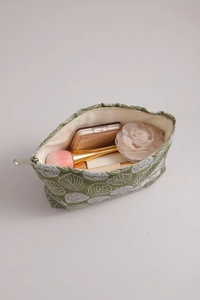 Detail view of cotton linen floral makeup bag with metal zipper and interior storage