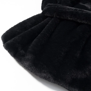 Detailed macro view showing the soft texture of black faux fur plush jacket fabric