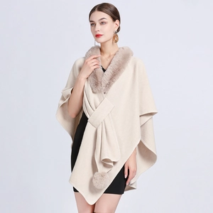 Elegant cream knit cape cloak with plush faux fur collar and decorative pom-pom ties