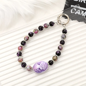 Vintage cameo beaded phone charm with purple relief and metallic accent keyring