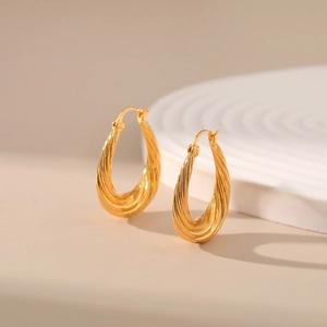 Detailed shot of 18K gold plated brass hoop earrings with elegant twisted rope texture