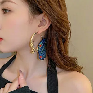 Vintage style gold hoops with detailed blue embroidered butterfly charm for women