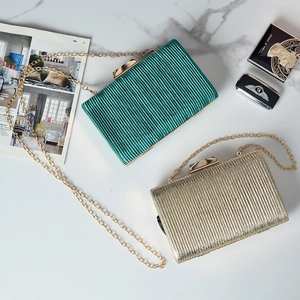 Ruched clutch bag with gold chain strap in emerald green and champagne gold tones