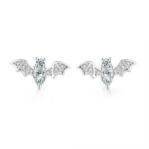 Macro shot of silver bat stud earrings with sparkling cubic zirconia wing details