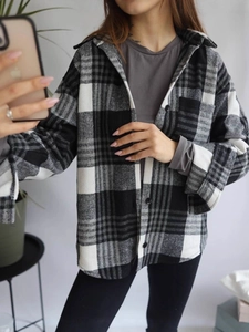 Relaxed black and white plaid flannel shirt jacket with long sleeves and buttons