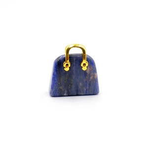 Detail shot of mini handbag pendant in deep blue natural stone with gold handle