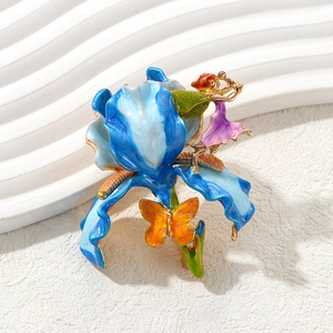 Vintage enamel fairy and blue flower brooch with butterfly detail on white wavy base