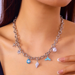 Detailed close-up of a silver chunky chain necklace with starfish and whale tail charms