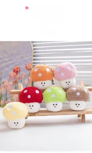 Detailed view of colorful plush mushroom keychains with cute faces on wooden display