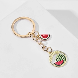 Detail of gold-plated watermelon keychain with enamel charms and Watermelon text