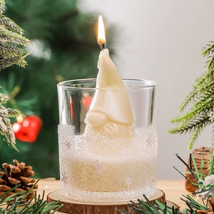 Handmade Santa Claus scented candle in glass jar with festive Christmas decor