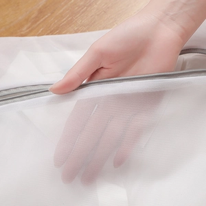 Thickened fine mesh laundry bag with grey zipper shown on a wooden background