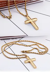 Macro detail of classic gold cross pendant with high-shine finish and thick rope chain