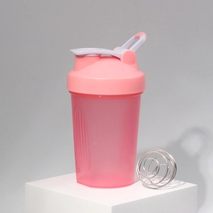 Pink fitness shaker bottle with clear volume scale and stainless steel mixing ball