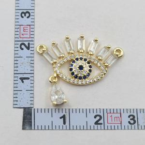 Macro view of gold Evil Eye pendant with blue zircon stones and size measurement