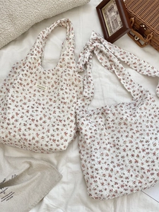 Floral canvas shoulder bags in cream with red flowers and knotted strap detail
