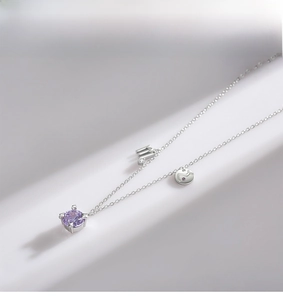 Macro detail of S925 silver Scorpio necklace featuring a round purple gemstone pendant