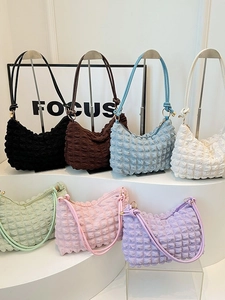 Bubble textured popcorn crescent bags in seven vibrant colors on creative display stands