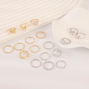 Detail of 17-piece vintage gold and silver ring set featuring pearls and floral motifs