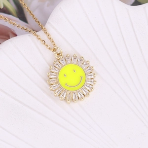 Golden sunburst smile necklace with micro-pave cubic zirconia on textured background