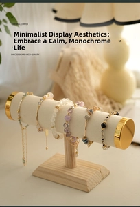 Detail of wooden bracelet display stand with various beaded jewelry in home setting
