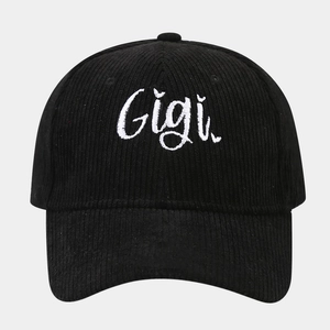 Detailed close-up of Gigi embroidery on a black corduroy texture baseball cap