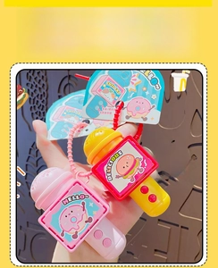Macro detail of cartoon food-themed microphone toys featuring burger and donut motifs