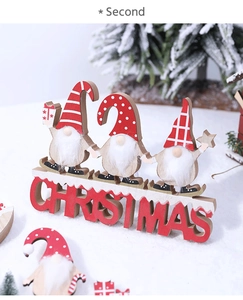 Detail of wooden Christmas gnomes on snow base with red CHRISTMAS lettering