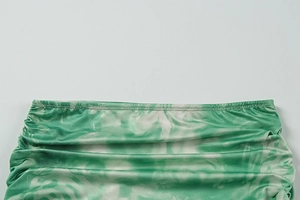 Close-up of green and white marble print fabric with ruched elastic stitching details