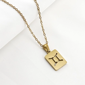 Detailed macro view of gold square pendant featuring镂空Gemini zodiac symbol and brushed texture