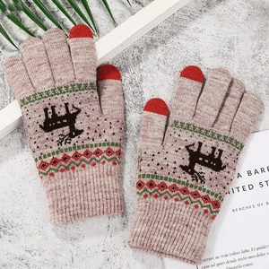 Close-up of pink-grey knit gloves with reindeer pattern and red touchscreen fingertips