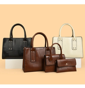 Detail view of five-piece set faux leather handbags featuring crocodile embossed texture