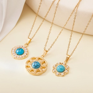 Three gold stainless steel necklaces with turquoise stones and faux pearls detail